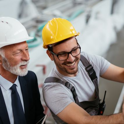 older white man in a suit with a young male engineer - Preserving engineering expertise and bridging the skills gap