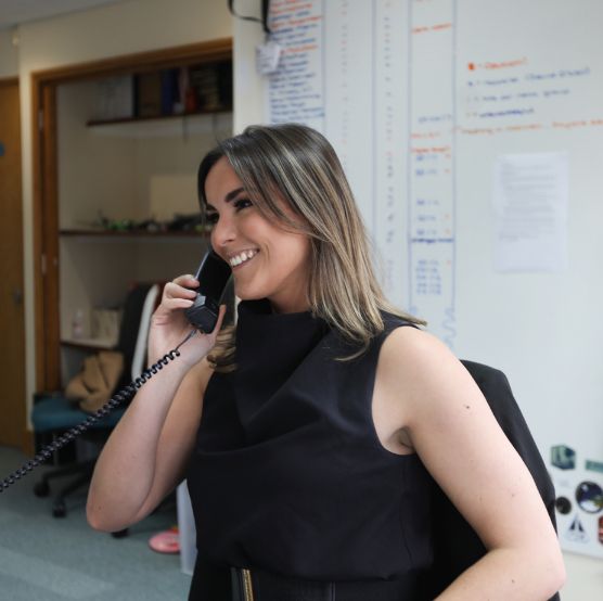 Female recruitment consultant at desk on a call