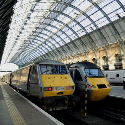 Two trains stationery in a mainline train station