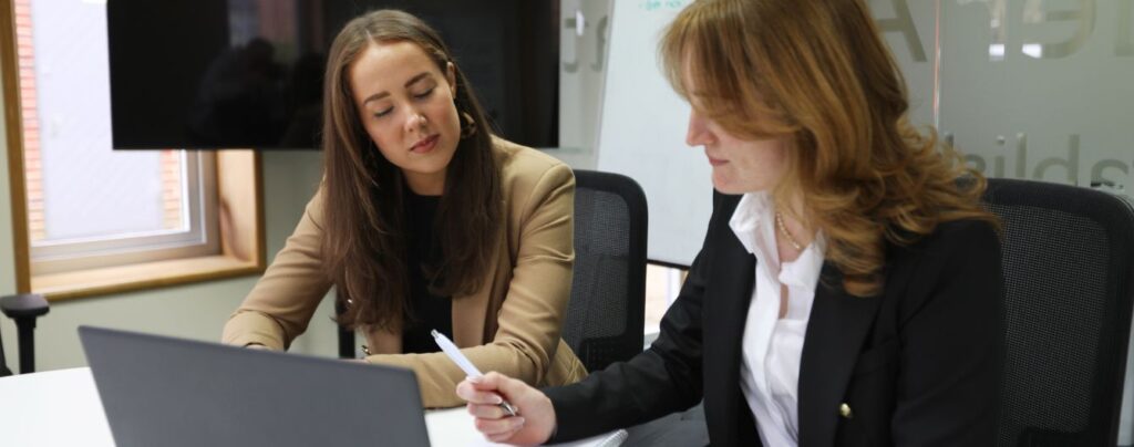 Two female Alexander Associates colleagues in a meeting