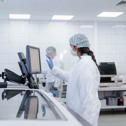 Scientist operating equipment in a laboratory.